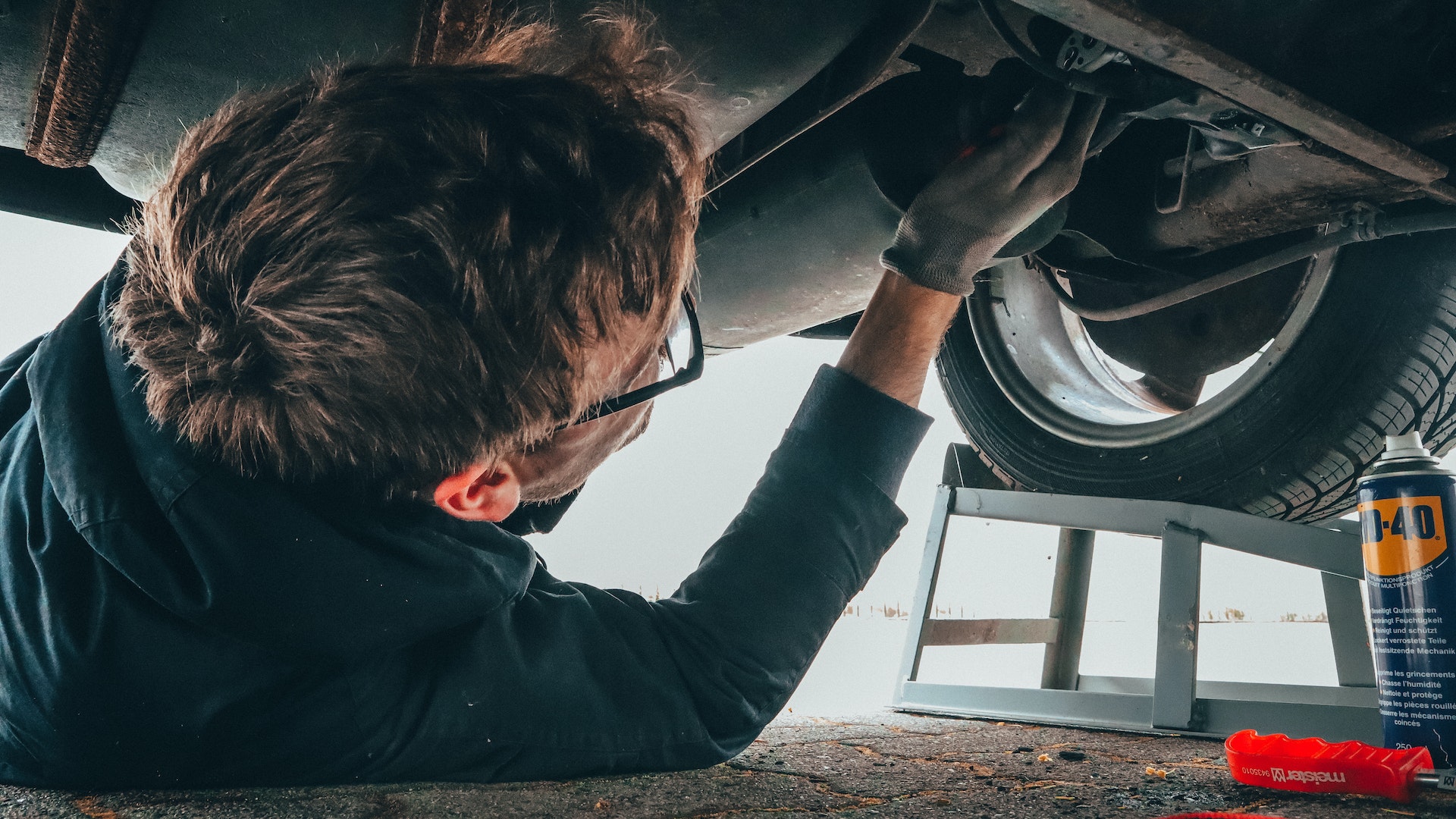 Man fixing vehicle - Understanding the Root Causes Behind Car Accidents - FR-44 insurance